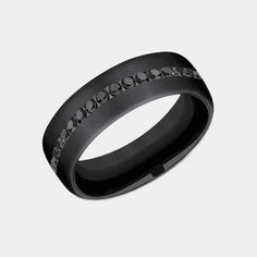 Introducing the Edison, a masterpiece of modern jewelry design that marries the sleek, enduring appeal of black titanium with the opulent brilliance of black diamonds. This 6.5mm comfort fit wedding band is a symphony of sophistication and strength, featuring a satin finish on black titanium that serves as the perfect backdrop for the twenty channel-set black diamonds. With a total carat weight of .40ct, these diamonds sparkle with a mysterious allure, making the Edison not just a ring, but a st Elegant Titanium Wedding Rings, Elegant Tungsten Carbide Wedding Jewelry, Elegant Black Stainless Steel Rings, Elegant Black Bands For Anniversary, Elegant Black Anniversary Bands, Elegant Tungsten Carbide Wedding Rings, Elegant Wedding Rings In Tungsten Carbide, Classic Black Diamond Promise Ring, Modern Black Diamond Promise Ring