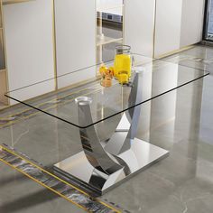 a glass table with silver and yellow accents in an empty room that looks like it could be used as a coffee table