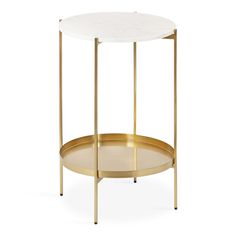 a white marble and gold metal side table with an oval tray on the bottom,