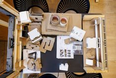 an overhead view of a table with boxes, cups and other items on top of it