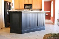 a kitchen island made out of cabinets in the middle of a room