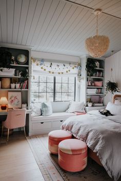 a bedroom with white walls and pink furniture