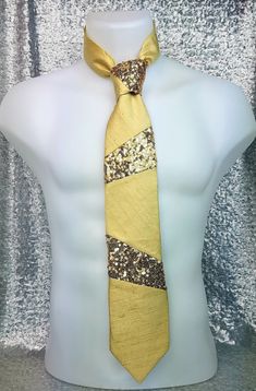 Sir Montie Designer Neckties Premier Collection - Ferdinand in Pale Gold Silk & Sequins   Ferdinand in Pale Gold Silk & Sequins: is beautifully hand crafted in a luxurious Pale Gold Dupioni Silk and a dazzling Gold Sequin.  This design is fully lined in a crisp Satin Lining with a Mod Dot Print and finished with a chic Damask woven label; which includes the Sir Montie logo and brand name.  Ferdinand in Pale Gold Silk & Sequins: is the perfect neck tie for that holiday party, formal event, special celebration, a night out with that extraordinary someone, or just to spice up your everyday style at the workplace. Ferdinand in Pale Gold Silk & Sequins: is part of the Sir Montie Designer Ties Premier Collection which dazzles the imagination with stylish and creative designs fashioned with luxur Perfect Neck, Executive Fashion, Satin Noir, Designer Ties, Dupioni Silk, Gold Silk, Pale Gold, Woven Labels, Tie Accessories