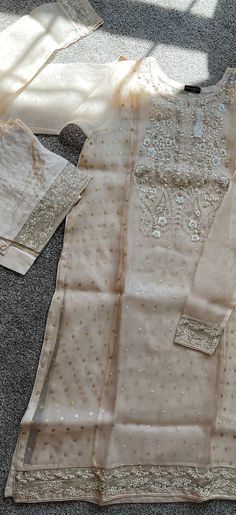 Original aghanoor  Brand new with tags 2 piece original aghanoor organza embroidered shirt with raw silk pant Sleeveless Slip comes separately  (included) Large shirt chest  44" Color: beige T Silk Pant, Silk Pants, Raw Silk, Embroidered Shirt, Salwar Kameez, 2 Piece, Silk, Tags, The Originals