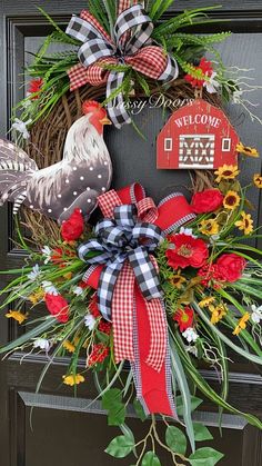 a wreath with roosters and flowers on it is hanging on the front door to welcome visitors