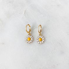 Dainty mini hoop earrings featuring a white daisy charm ❀❀ INFO: ❀❀ ➳ Hoop size: 12.5 mm x 14.5 mm ➳ Daisy charm size: 11 mm ➳ Hoops are gold plated stainless steel ➳ Daisy charm is gold plated brass ❀❀ PURPLE & GREEN DAISY EARRINGS: ❀❀ https://www.etsy.com/listing/1063301184/mini-daisy-hoop-earrings-in-lilac-purple?ref=shop_home_active_1 ❀❀ VIEW MORE EARRINGS: ❀❀ https://www.etsy.com/shop/bitsnpiecess/?section_id=23539584 ❀❀ SHIPPING & PROCESSING: ❀❀ Please refer to my shop announcement Trendy White Huggie Earrings For Everyday, Everyday Trendy White Huggie Earrings, Everyday Daisy-shaped Jewelry For Spring, Everyday Daisy-shaped Spring Jewelry, Cute White Huggie Jewelry, Nickel-free White Huggie Earrings, Trendy White Huggie Hoop Earrings, Trendy White Daisy Shaped Jewelry, Trendy White Daisy-shaped Jewelry