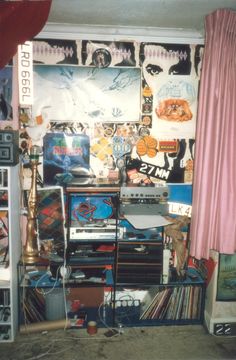 the room is cluttered with records and cds