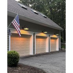 three garages with american flag hanging from the roof and two lights on each side