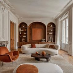 a living room filled with lots of furniture and bookshelves next to each other