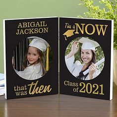 two personalized graduation cards on a table next to a potted plant and books