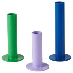 three different colored plastic objects on a white background