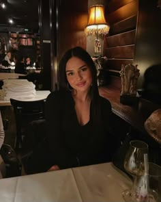 a woman sitting at a table in a restaurant