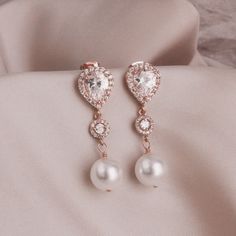 "Wedding Jewelry for Bride, Rose Gold Crystal Post Earring, Rose Gold Pearl Wedding Jewelry, Rose Gold Bridal Earring, Earring Gift for Bride * Rose gold tone cubic zirconia teardrop post with cubic zirconia center bead and finished with a white crystal pearl (10mm). The cubic zirconia teardrop is absolutely stunning. This pair of earrings measure 1 1/2\". * * Take 10% off $75 or more with coupon code ~ WEDDINGS10 * Take 15% off $100 or more with coupon code ~ WEDDINGS15 * This pair of earrings Rose Gold Pearl Earrings For Wedding, Rose Gold Pearl Earrings, Rose Gold Pearl Drop Bridal Earrings As Gift, Rose Gold Pearl Bridal Earrings For Formal Occasions, Rose Gold Flower Earrings With Pearl Drop For Wedding, Luxury Rose Gold Pearl Earrings For Wedding, Pearls Wedding Theme, Jewelry For Bride, Bridesmaid Pearl Bracelet