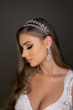 a beautiful woman wearing a tiara with pearls on it's head and long hair