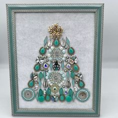 Vintage jewelry tree in light green melon color made with a vintage gold-tone rose and faux pearl brooch, vintage necklace pieces with teardrop crystals, marquis-shaped bracelet pieces, small vintage ladybug brooch, light green plastic teardrop beads, round light jade green glass beads, faux pearls, gold tone filler pieces, iridescent rhinestones, petite beaded earrings. Wood frame with easel back and wall-hanging hardware attached. Unique Collectible Jeweled Jewelry, Artistic Green Jewelry For Party, Unique Jeweled Jewelry As Gift, Unique Jeweled Jewelry For Gifts, Unique Jeweled Jewelry For Anniversary, Unique Collectible Teardrop Jewelry, Unique Teardrop Collectible Jewelry, Vintage Green Jewelry With Unique Variations, Green Jeweled Teardrop Jewelry