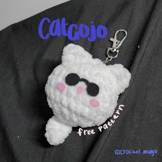 a white cat keychain with sunglasses on it