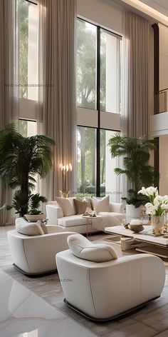 an elegant living room with white furniture and large windows