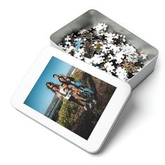 two people standing next to each other in front of a tin with puzzles on it