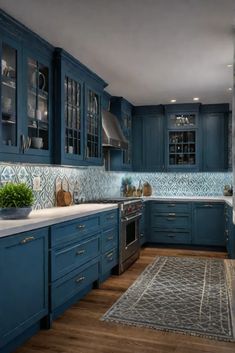 a kitchen with blue cabinets and white counter tops is pictured in this image, the area rug has been placed on the hardwood floor