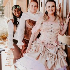 three women dressed in costume posing for a photo