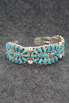 This turquoise and sterling silver bracelet was made by Navajo silversmith Jaz Wilson. The inside is signed J Wilson and S/S.Size: 5 3/4" (will fit up to a 6 1/2" wrist)Gap: 3/4"Width: 7/8"Free shipping on all orders! We ship with USPS and always include tracking. All orders ship within a day of payment.Returns are accepted up to 30 days after you receive your order. Just send us a message. Our shop offers cash back or store credit. The item must be returned in new condition. Southwestern Style Blue Sterling Silver Bracelet, Southwestern Blue Sterling Silver Bangle Bracelet, Southwestern Style Turquoise Inlay Bracelets, Southwestern Blue Sterling Silver Bangle, Collectible Bohemian Blue Sterling Silver Bracelet, Southwestern Turquoise Inlay Bracelet, Southwestern Sterling Silver Bracelet With Turquoise Inlay, Southwestern Silver Bracelet With Multi-stone, Southwestern Turquoise Inlay Sterling Silver Bracelet