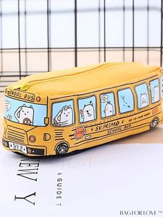 a yellow school bus pencil case sitting on top of a table