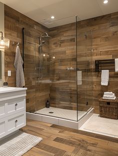 a bathroom with wooden walls and flooring, including a walk - in shower area