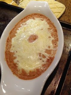 a bowl of soup sitting on top of a stove