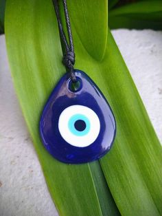 Clear Blue glass stained with indigo blue color, painted evil eye pendant. Necklace is adjustable with a black cord Blue Adjustable Amulet Necklace, Blue Evil Eye Necklace, Gift Envelope, Eye Glass, Lace Headbands, Blue Evil Eye, Eye Pendant, Evil Eye Pendant, Evil Eye Charm