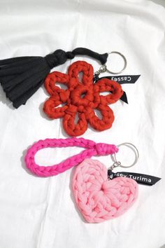 three different types of key chains with tassels attached to them on a white sheet