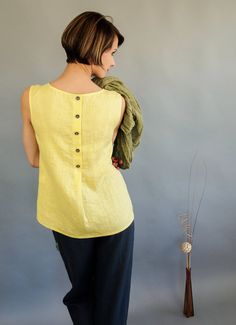 I guest every woman craves to have a top, that looks great, cover all the delicate areas (despite how good each of us look, we tend to find some flaws in our body) and has multi-occasional purpose. This minimalist design , sleeveless linen women top, sewn from highest quality Lithuanian linen is your answer for all these questions. Linen fabric is soft and light, perfect for hot summer days. Top has elegant buttons from the back side, that serve as a lovely decoration. There is also subtle geome Summer Ramie Blouse, Summer Beach Blouse Made Of Ramie, Summer Beach Blouse In Ramie, Summer Vacation Ramie Tops, Summer Linen Blouse In Flax Color, Linen Sleeveless Blouse For Summer, Sleeveless Linen Blouse For Summer, Summer Sleeveless Linen Blouse, Linen Blouse Designs