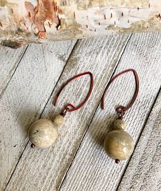 These are 15mm JASPER stones. The ear wires are torched copper that has a unique rose copper finish. Jasper is known for it's grounding effect. Rustic Copper Earrings With Ear Wire, Rustic Copper Drop Earrings, Earthy Brown Copper Earrings, Adjustable Wire Wrapped Brown Earrings, Adjustable Brown Wire Wrapped Earrings, Adjustable Rust Earrings With Ear Wire, Rust Dangle Earrings With Ear Wire, Rust Color Dangle Earrings With Ear Wire, Earthy Bronze Earrings With Ear Wire