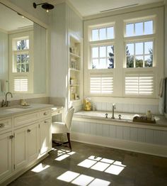 a large bathroom with two sinks and a bathtub in the middle of the room