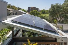 solar panels on the roof of a modern home in sydney, australia by corb design studio