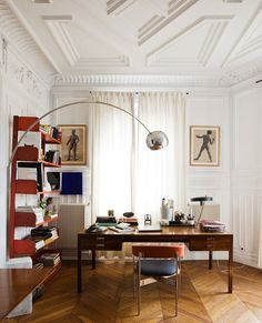 a room with a desk, chair and bookshelf