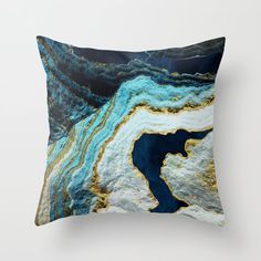 a blue and gold marble pillow on a white wall