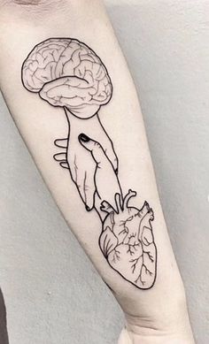 a person with a tattoo on their arm that has a drawing of a human hand holding a heart