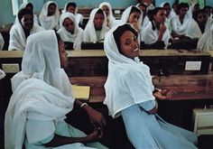 a group of women sitting in front of desks