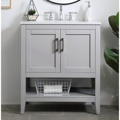 a white sink sitting under a mirror next to a wall mounted faucet in a bathroom