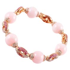 Purchased from famed jewelry designer David Morris of London, this lovely bracelet is in warm and inviting 18 karat rose gold and the pink color in the six beautifully matched opals is complimented by the bright sparkle of the 2.14 carats of pink sapphires and 3.55 carats of dazzling diamonds! The current Retail Replacement Value is $20,000 as stated by the manufacturer. Platinum Sapphire Ring, Diamond Gold Bracelet, Blue Honey, White Gold Sapphire Ring, Chandelier Gold, Gold Diamond Hoop Earrings, Pearl And Diamond Necklace, Art Deco Bracelet, White Sapphire Ring