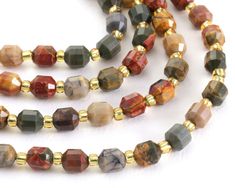 Beautiful blends of earth tones combine on this Red Creek jasper energy tube strand. Petite and sparkly, this strand features unique patterning on every bead. Precision cut by lasers, our prism-style beads are faceted masterpieces perfect for elegant earrings and layered necklaces. Each bead has 12 sides showing off the beautiful pattern and color of the stone. This style is often referred to as lucky faceted or crystal energy prism beads and is believed to bring forth positive energy. Red Creek Jasper might be THE Autumn gemstone. Seriously, this stone has it all - gorgeous olive greens, soft grays, mustard yellows, charcoal blacks, and rusty reds. Add this stone to your collection, and remind yourself of autumnal walks in the woods all year long. Red Creek Jasper is also known as Cherry Red Creek Jasper, Crystal Energy, Beads Online, Bead Store, Walk In The Woods, Long Red, Energy Crystals, Precision Cut, Elegant Earrings