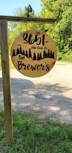 a wooden sign that says, we are the brewer's with trees in the background