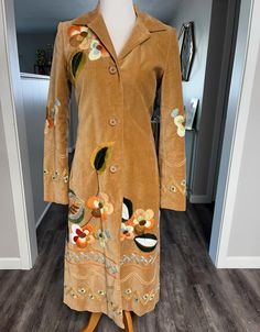 Gorgeous, vintage embroidered coat by BIYA. Size S and in very good vintage condition. Smoke free/pet free home. Beautifully lined, spare button still attached. Has pockets. My mannequin is a size 4 and I am a size 6 and it fits beautifully. There are small signs of wear (as pictured) but nothing that distracts from the absolute beauty of this coat.   43 inches in length, 25 inch sleeves, 17 inch (pit to pit buttoned). Perfect for Fall and Winter Vintage Long Sleeve Outerwear With Floral Embroidery, Vintage Long Embroidered Outerwear, Vintage Long Spring Outerwear, Vintage Floral Embroidery Outerwear For Fall, Vintage Floral Embroidered Outerwear For Fall, Vintage Brown Embroidered Outerwear, Fitted Embroidered Vintage Outerwear, Embroidered Coat, Small Signs