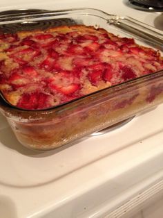 a casserole dish with strawberries in it on the stove