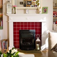 a living room filled with furniture and a fire place in front of a white fireplace