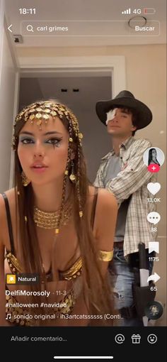 a woman with long hair wearing gold jewelry and a man in a cowboy hat standing behind her