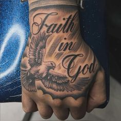 a man with a tattoo on his hand that says faith in god and an eagle