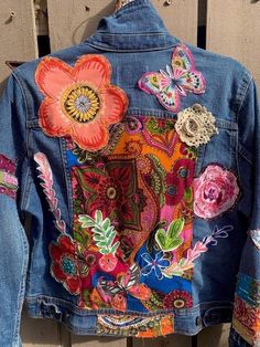 a denim jacket with flowers and butterflies on it