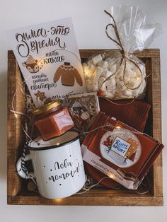 a gift box with coffee, marshmallows, and other items in it