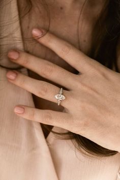 a woman's hand with a diamond ring on it